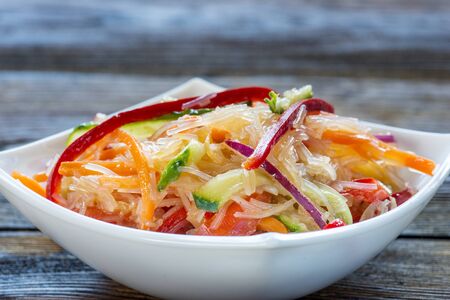 Rise noodles and vegetables in   white elegant plateの写真素材