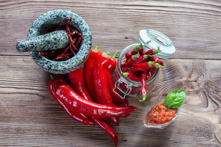 Closeup of organic red Jalapeno peppers spilling out of mason jar