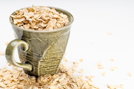 A healthy breakfast of oatmeal in a  rustic style cupの写真素材