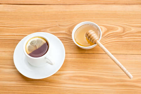 Herbal tea in a cup with  and honey on rustic wooden backgroundの写真素材