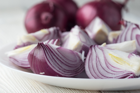 Bowl of sliced organic red onions on Wooden background.の写真素材