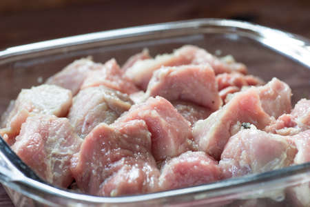 Raw slices of pork mea in glass bowl ready for BBQの写真素材