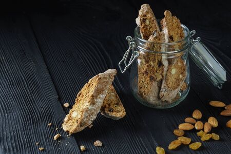 Italian cantuccini cookie with almond filling on dark wooden backgroundの写真素材