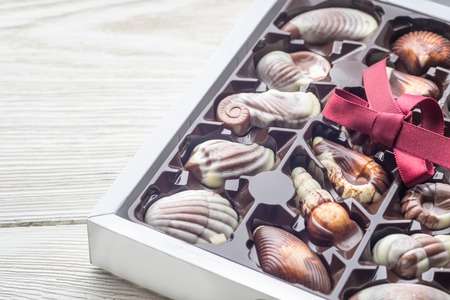 Close-up top view of various chocolate pralines. Sweet food background. Assortment of fine Belgium...
