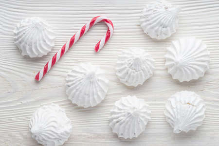 Many sweet zephyrs on wood background. Trendy top view dessert image. Christmas composition. Winter swwwts. Bakery products top view.の写真素材