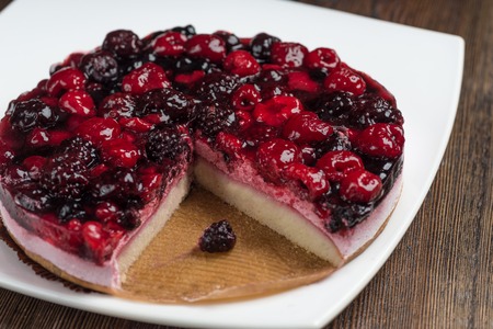 Close up. Creamy mascarpone cheese cake with raspberry and winter berries. New York Cheesecake. Close up. Christmas dessert. Healthy food.の写真素材