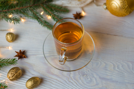 White table with a glass teapot and christmass decorations on a white rustic table.の写真素材