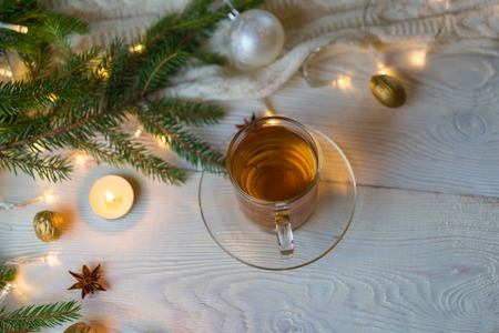 White table with a glass teapot and christmass decorations on a white rustic table.の写真素材