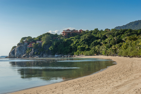 White sandy tropical beach with calm waves and sunny dayのeditorial素材