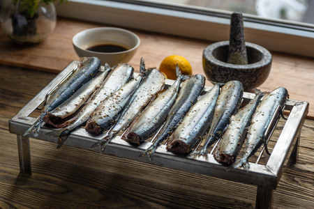 Appetizing saury fish grill for smoking. Smoked saury. Smoked fish with spicesの写真素材