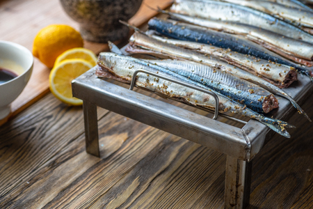 Appetizing saury fish grill for smoking. Smoked saury. Smoked fish with spicesの写真素材