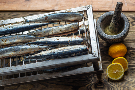 Appetizing saury fish grill for smoking. Smoked saury. Smoked fish with spicesの写真素材