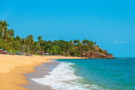 Beautiful beach with palm trees and moody sky. Summer vacation travel holiday background concept. Thailand paradise beach. Luxury travel summer holiday background concept.の写真素材