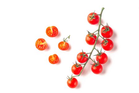 Ripe fresh juicy organic cherry tomatoes on branch isolated on a white background.の写真素材