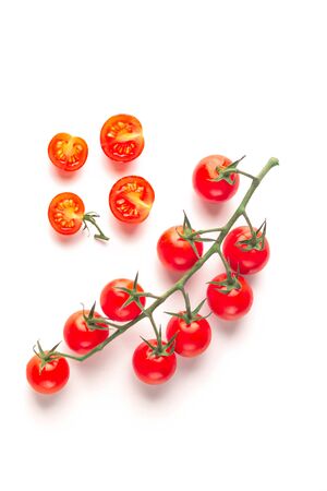 Ripe fresh juicy organic cherry tomatoes on branch isolated on a white background.の写真素材