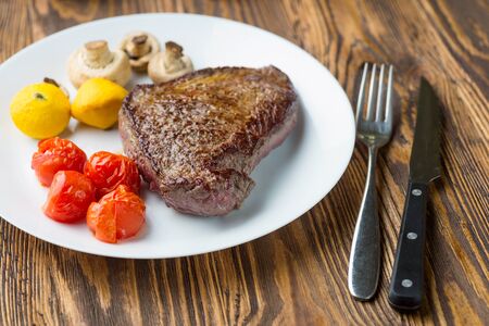 BBQ Steak. Barbecue Grilled Beef Steak Meat with Vegetables. Healthy Food. Barbeque Steak Dinnerの写真素材