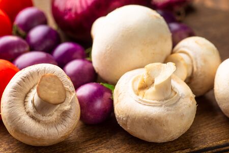 Vegetables and mushrooms on a dark wooden rustic table.  Tomatoes, eggplant, onions,  Rural still life.の写真素材