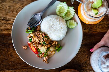Stir-fried minced pork with onion, pepper and steamed rice (Thai food)の写真素材