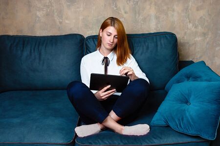 Business woman relaxing at home after working sitting on the sofa.の写真素材