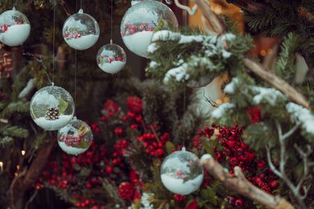 Christmas outdoor background with fir tree branches, decorations with glass balls.の写真素材