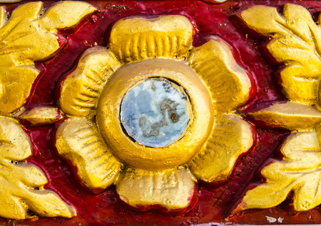 gold flower on red backgroundの写真素材