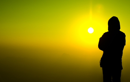 man in silhouette on color skyの写真素材