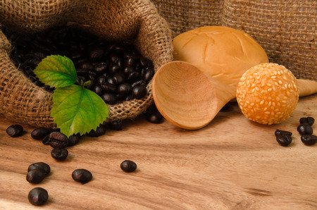 coffee bean in sack with Orange Jessamine on wooden backgroundの写真素材