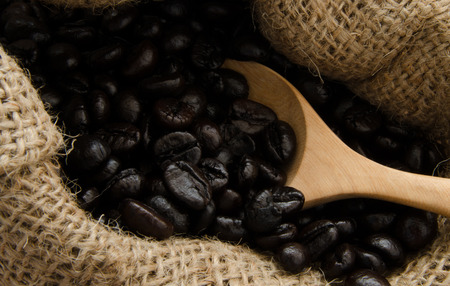 wooden spoon on coffee sackの写真素材
