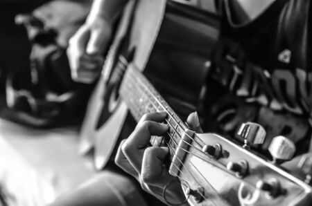 female hand on classical guitar , black and white colorの写真素材