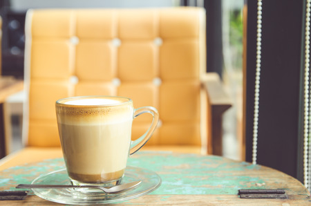 Cup of coffee on wooden table in coffee cafeの写真素材