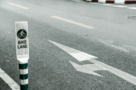 bike lane sign on cement roadの写真素材
