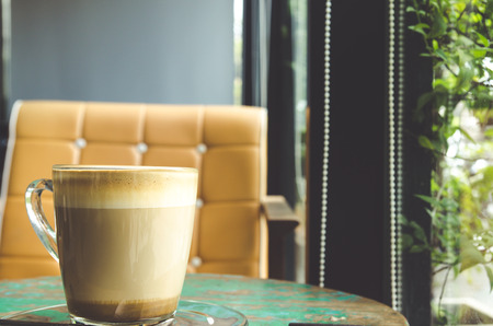 Cup of coffee on wooden table in coffee cafeの写真素材