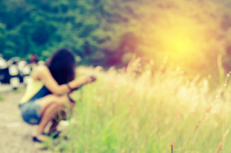 blurred women photography on grass field with process in vintage styleの写真素材