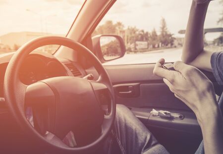 man using cellphone on drive in carの写真素材