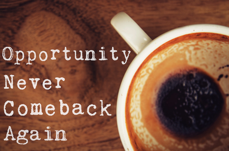 coffee cup  on wooden table with motivation quote