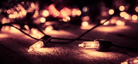 christmas light decor on wood background , color filter vintage toneの写真素材