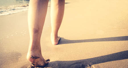foot walk on sand beach , travel , discovery conceptの写真素材