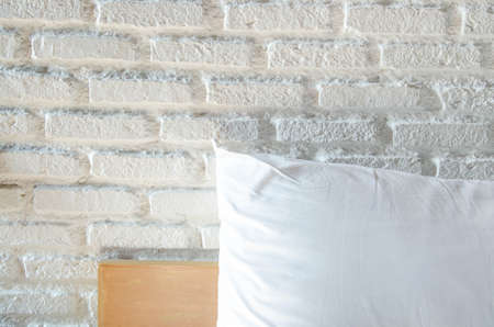 Pillows on bed with white brickwall background loft styledの写真素材