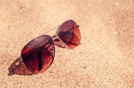 blurred abstract Fashion sunglass on the summer beach at ocean background , vintage filter , Summer vacation actually relaxing, summer concept , vocation time , summer backgroundの写真素材