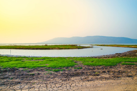 landscape photo of river  and meadow with blur mountain background
