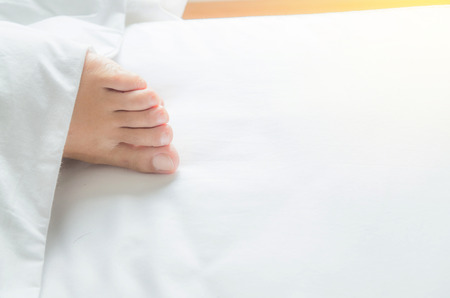 woman feet on the bedの写真素材