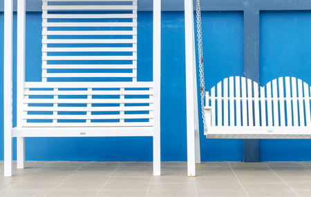 white wood swing on blue backgroundの写真素材