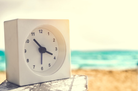 modern alarm clock on beachの写真素材