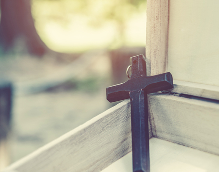 Old cross on a brown wood backgroundの写真素材