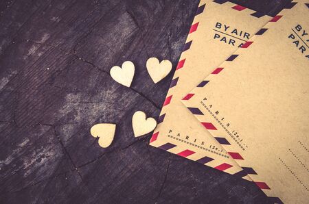 Blank paper card with brown envelop on wooden board to parisの写真素材