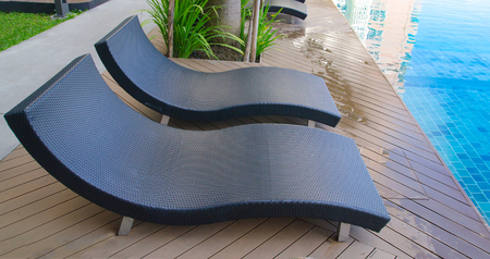 Relaxation with Rattan chair side swimming poolの写真素材
