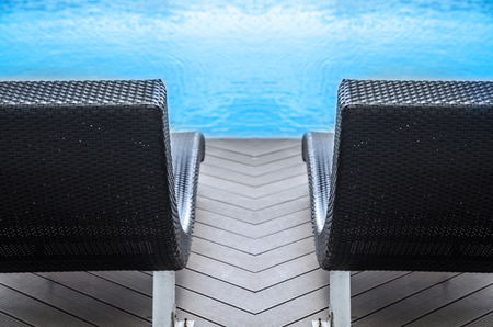 Relaxation with Rattan chair side swimming poolの写真素材