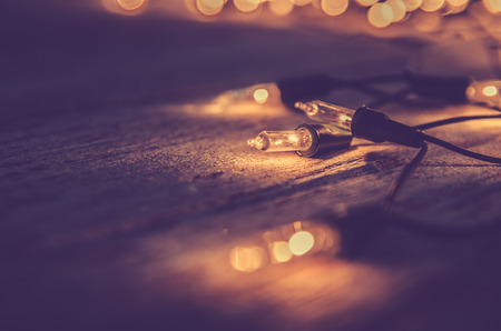 christmas light decor on wood background , color filter vintage toneの写真素材