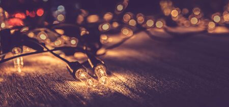 christmas light decor on wood background , color filter vintage toneの写真素材
