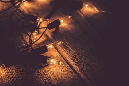 christmas light decor on wood background , color filter vintage tone , selective focusの写真素材